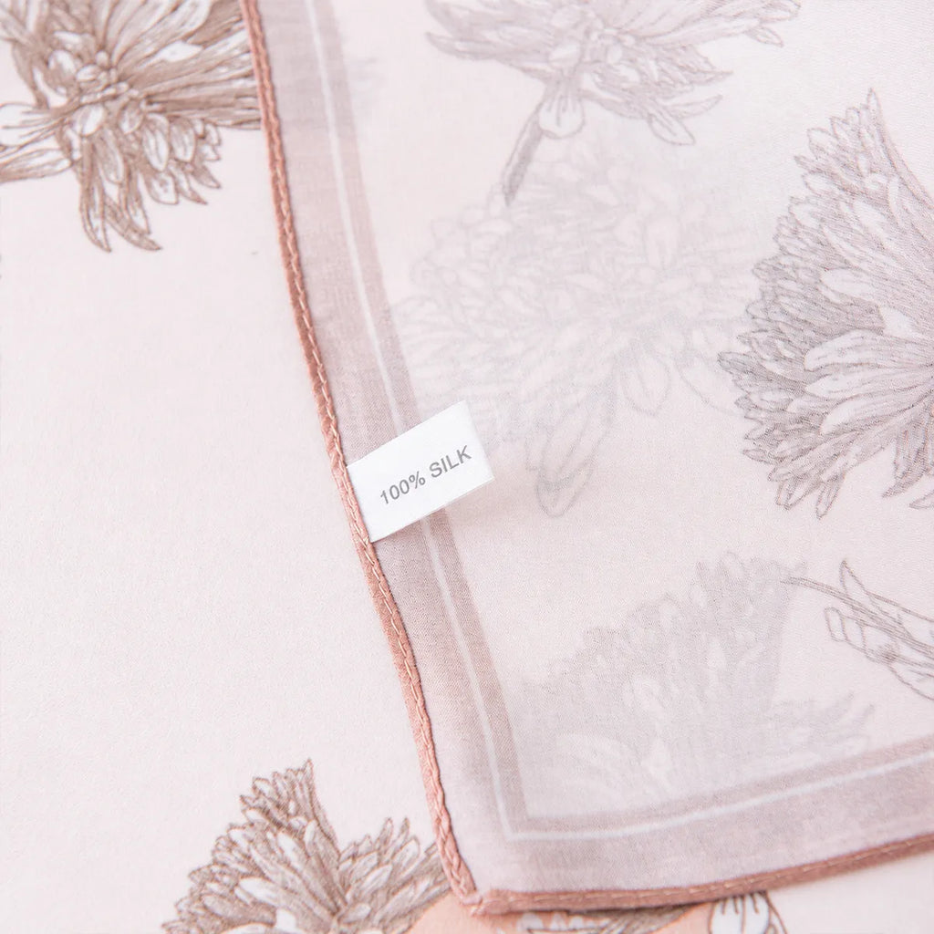 100% silk label attached to a pink botanical silk scarf