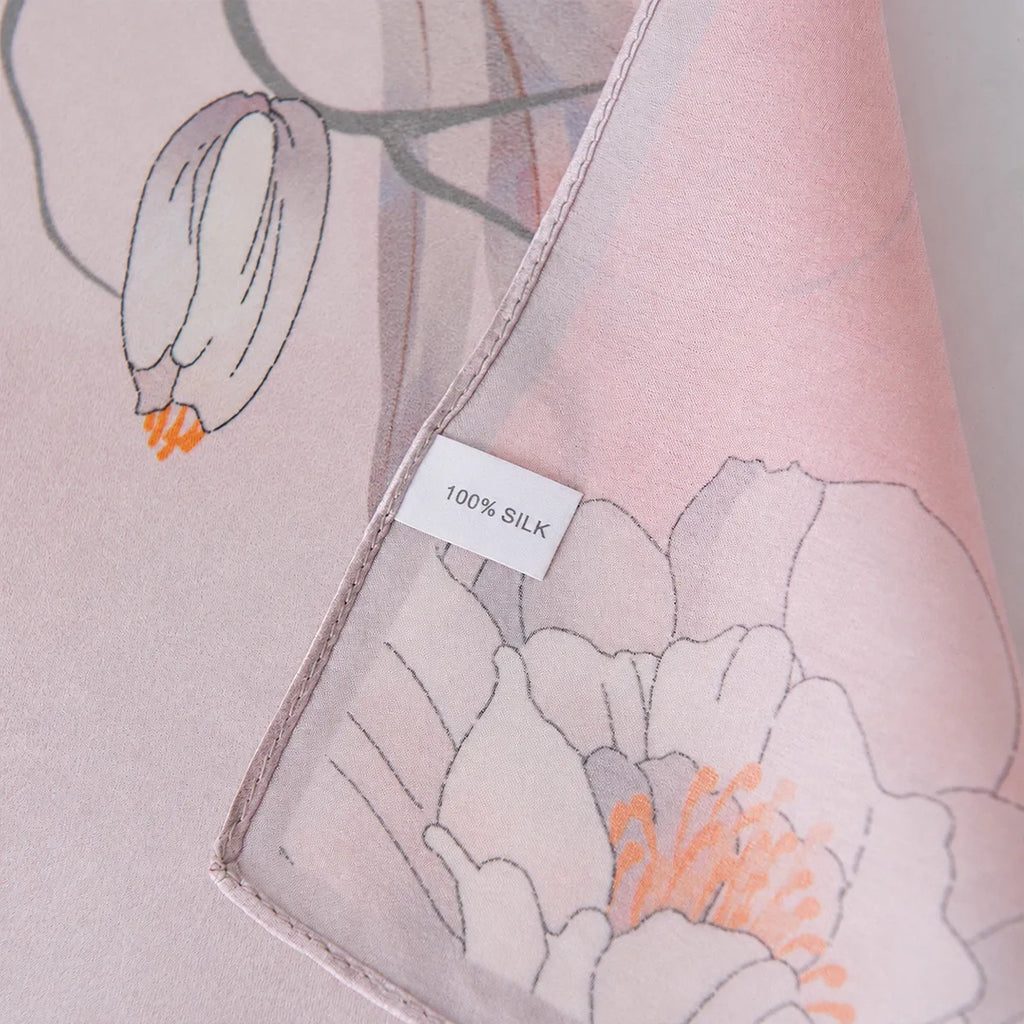 100% silk label on a light pink floral silk scarf