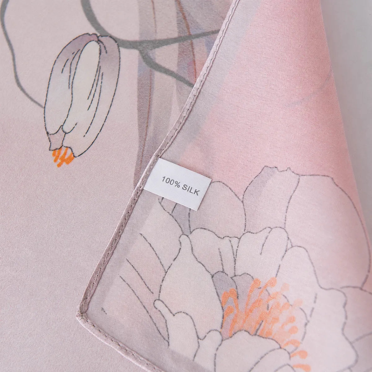100% silk label on a light pink floral silk scarf