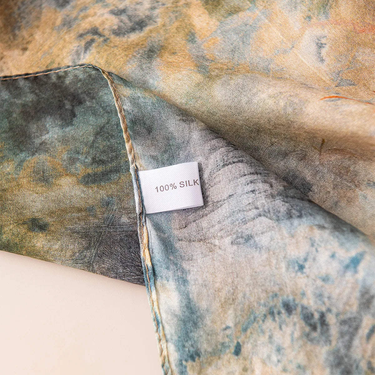 100% silk label on emerald watercolor scarf