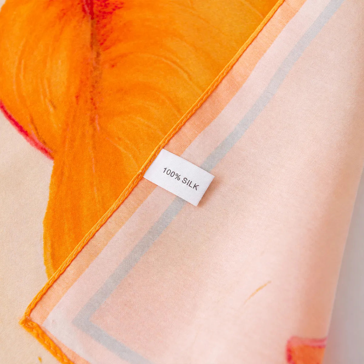 100% silk label on peach orange silk scarf
