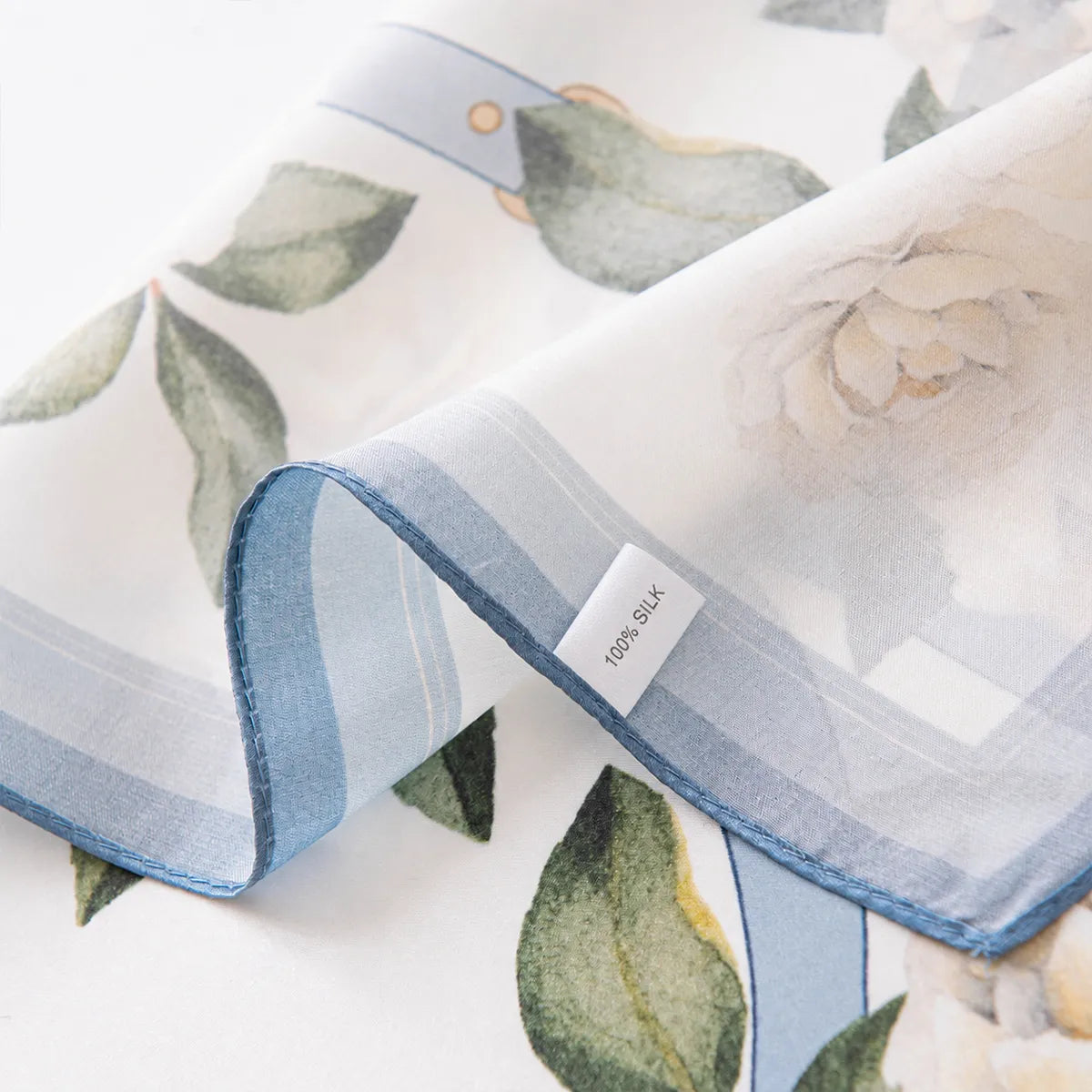 100% silk label on white scarf with blue edge