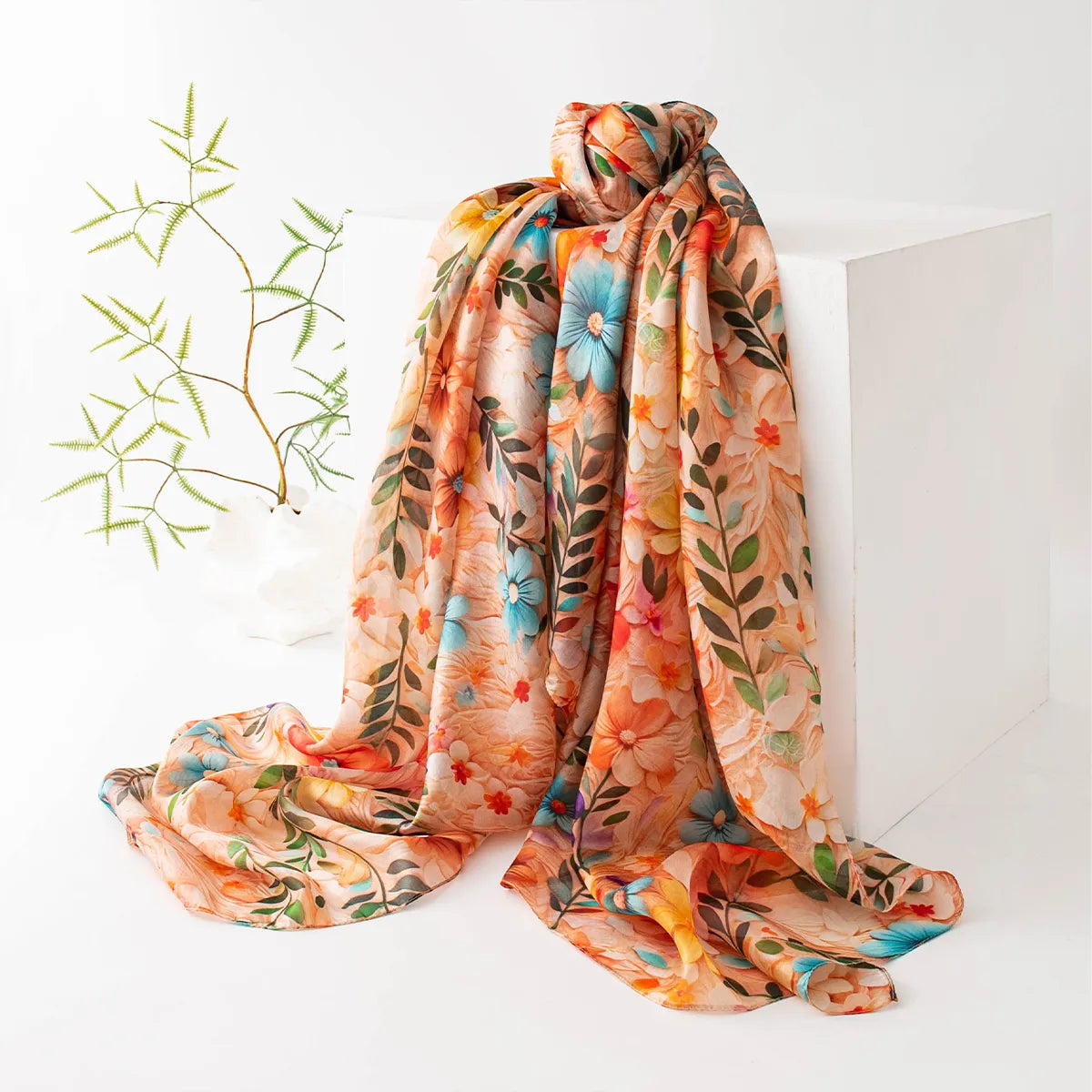 Apricot wildflower silk scarf on display stand