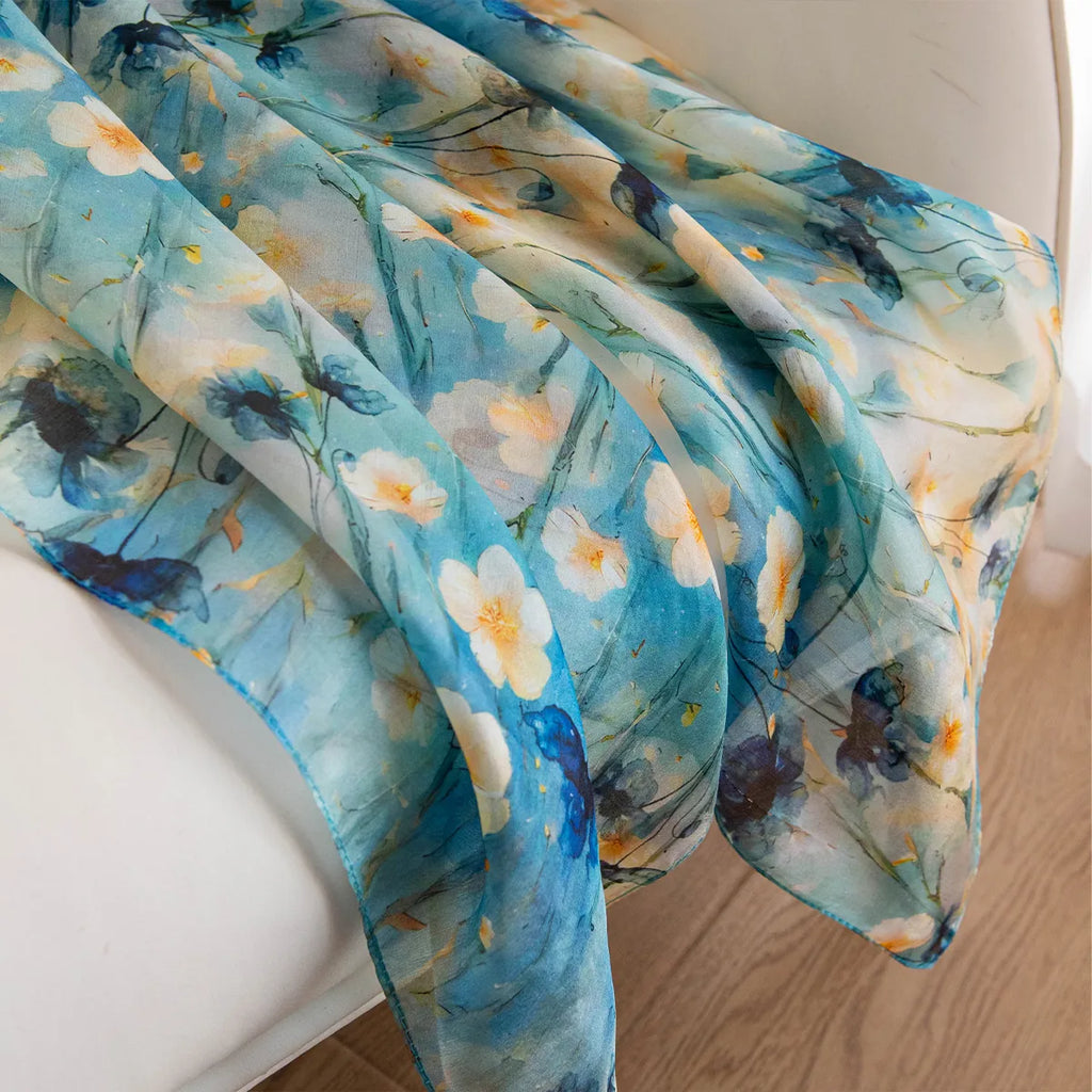 Aqua daisy silk scarf draped on chair