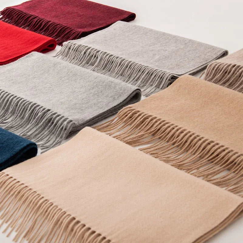 Assorted cashmere scarves arranged flat with fringed ends exposed