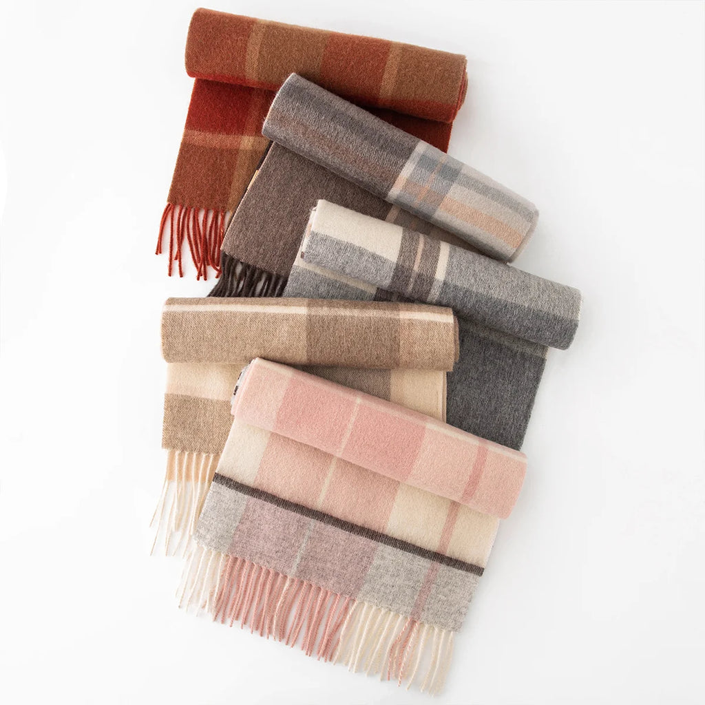 Assorted plaid wool scarves arranged in a vertical folded display