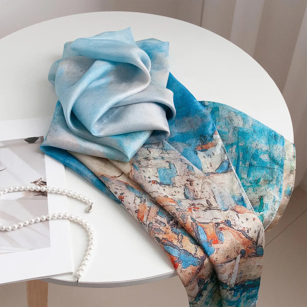 Azure sailboat silk scarf on table
