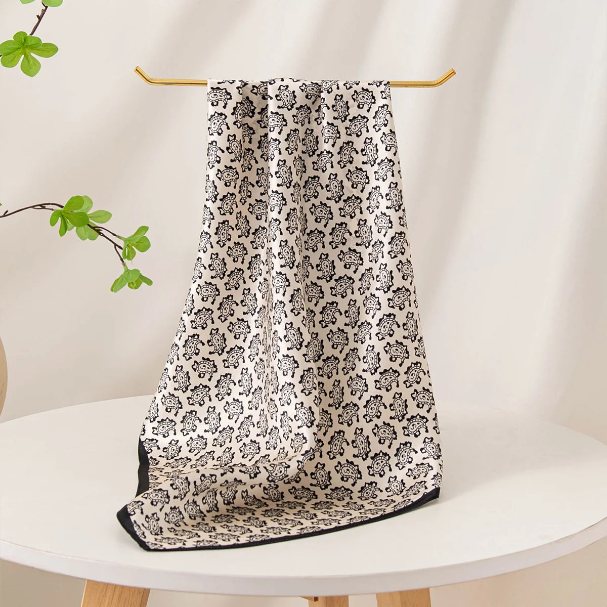 Black paisley Silk Square Scarf draped tabletop display