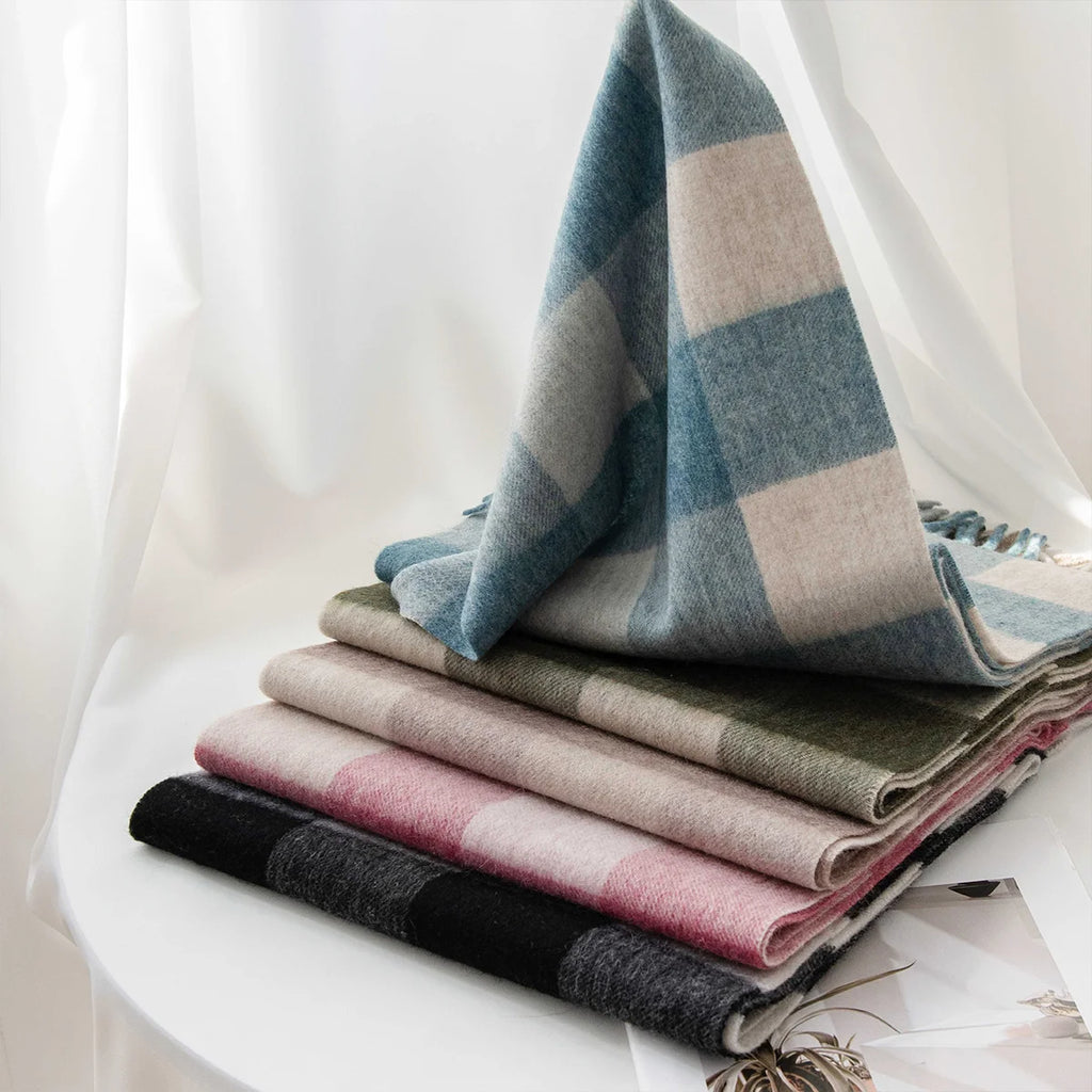 Blue checked wool scarf cascading over stacked color alternatives