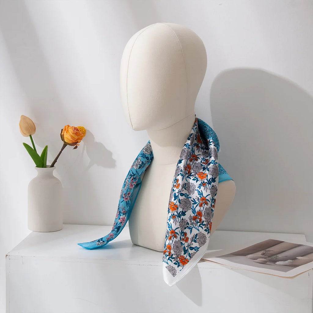 Blue floral silk scarf displayed on mannequin bust