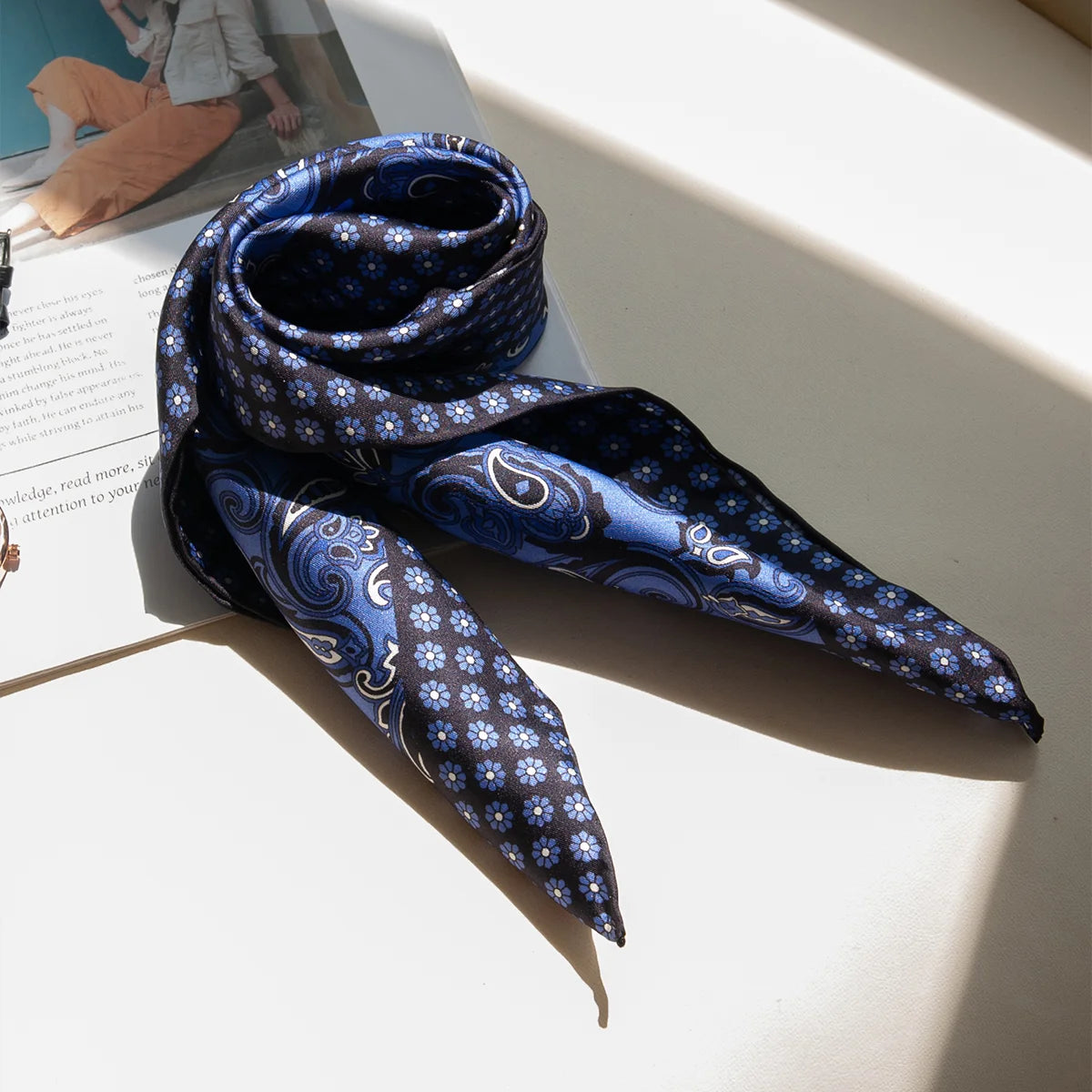 Blue paisley Silk Square Scarf folded in sunlight