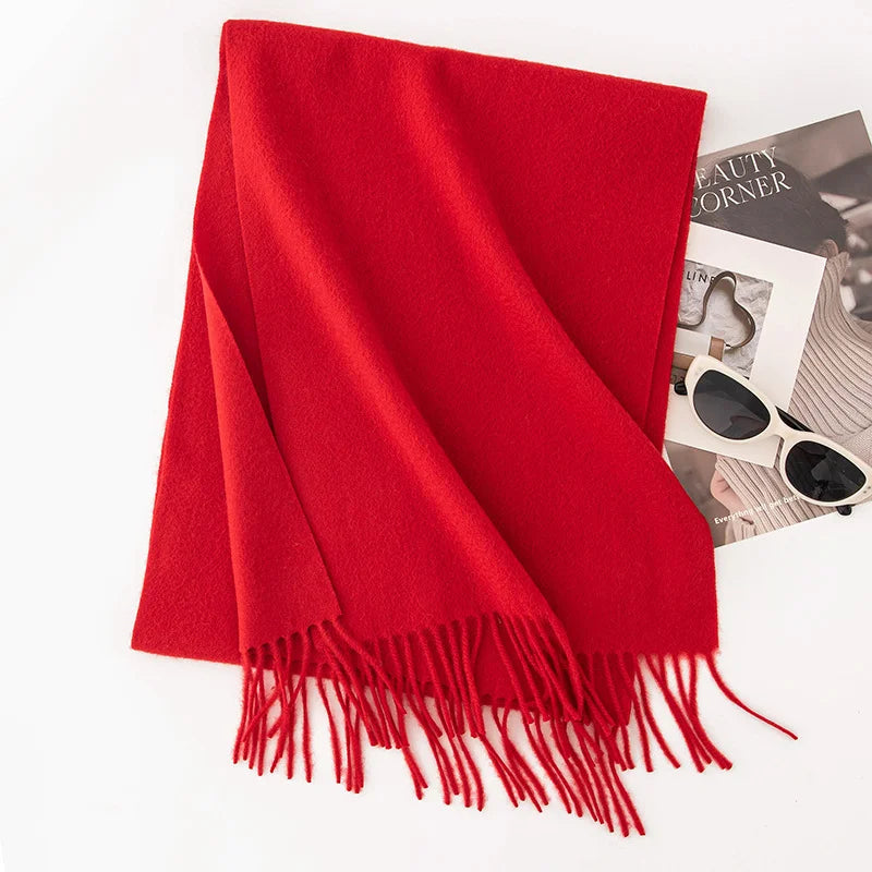 Bright red fringed scarf displayed on white background