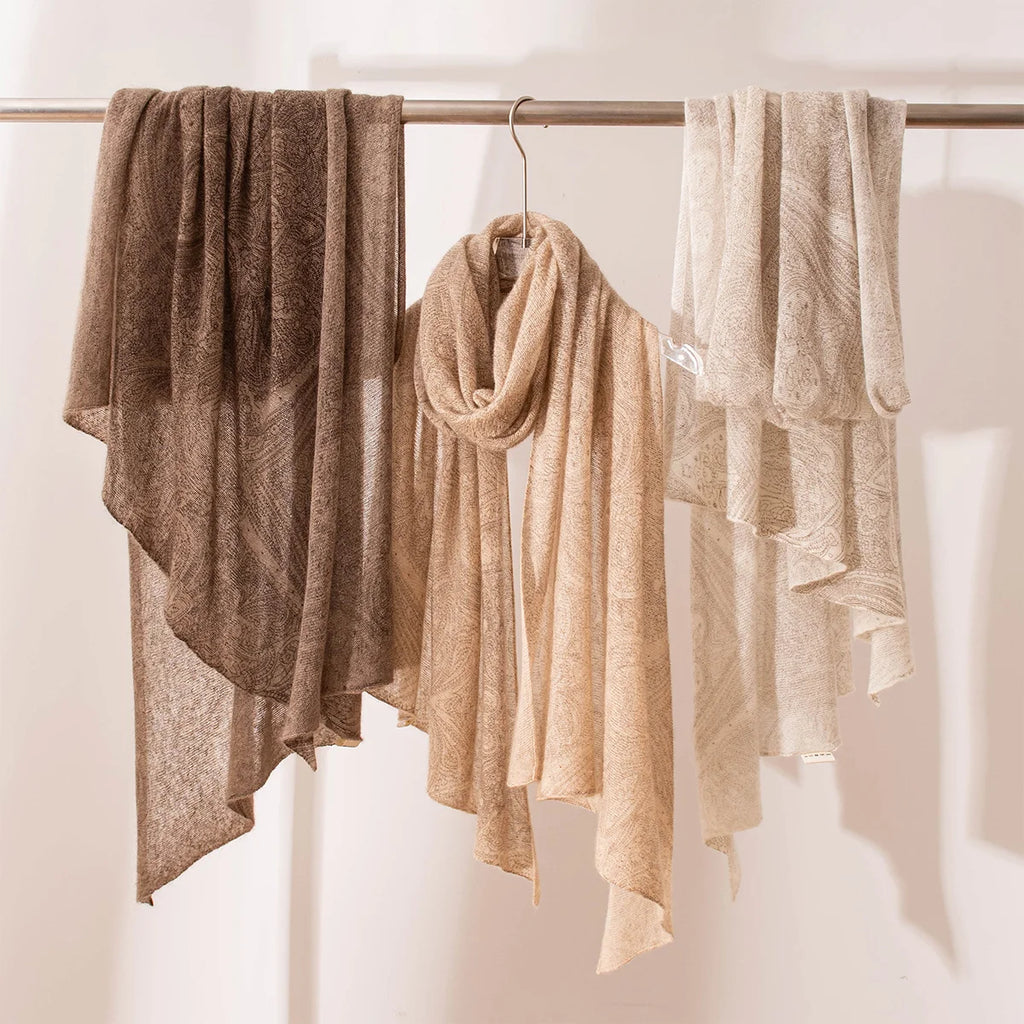 Brown camel and cream open weave cashmere scarves hanging together