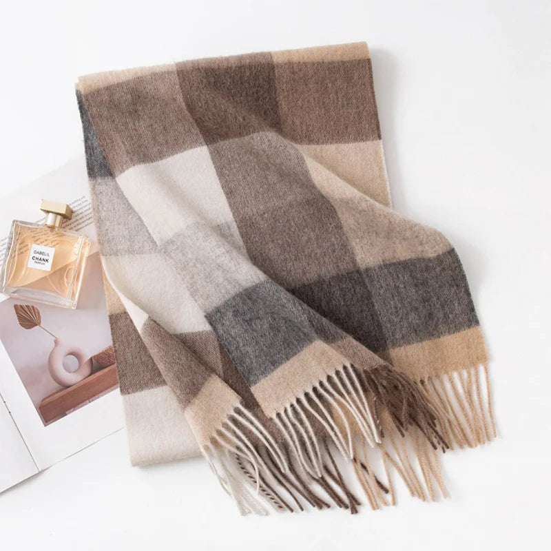 Brown gray cream checked wool scarf folded beside perfume bottle