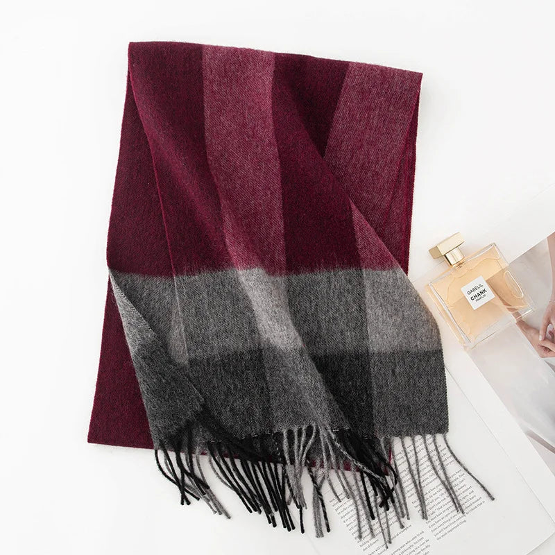 Burgundy gray crossband wool scarf folded beside a perfume bottle