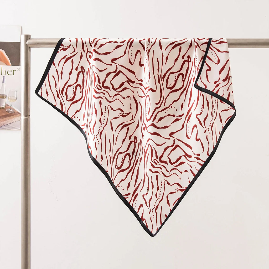 Burgundy line Silk Square Scarf draped tabletop display