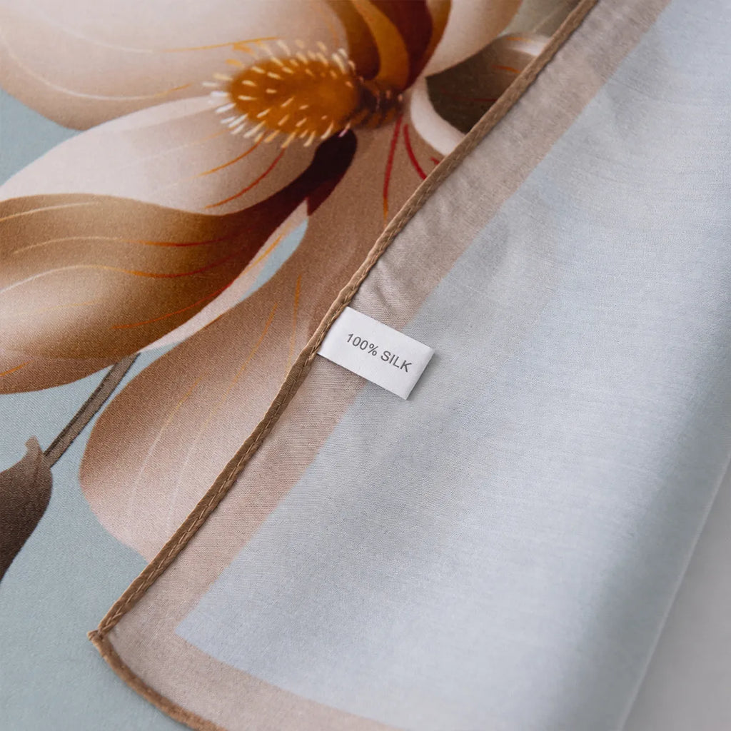 Close-up of 100% silk label on blue floral scarf
