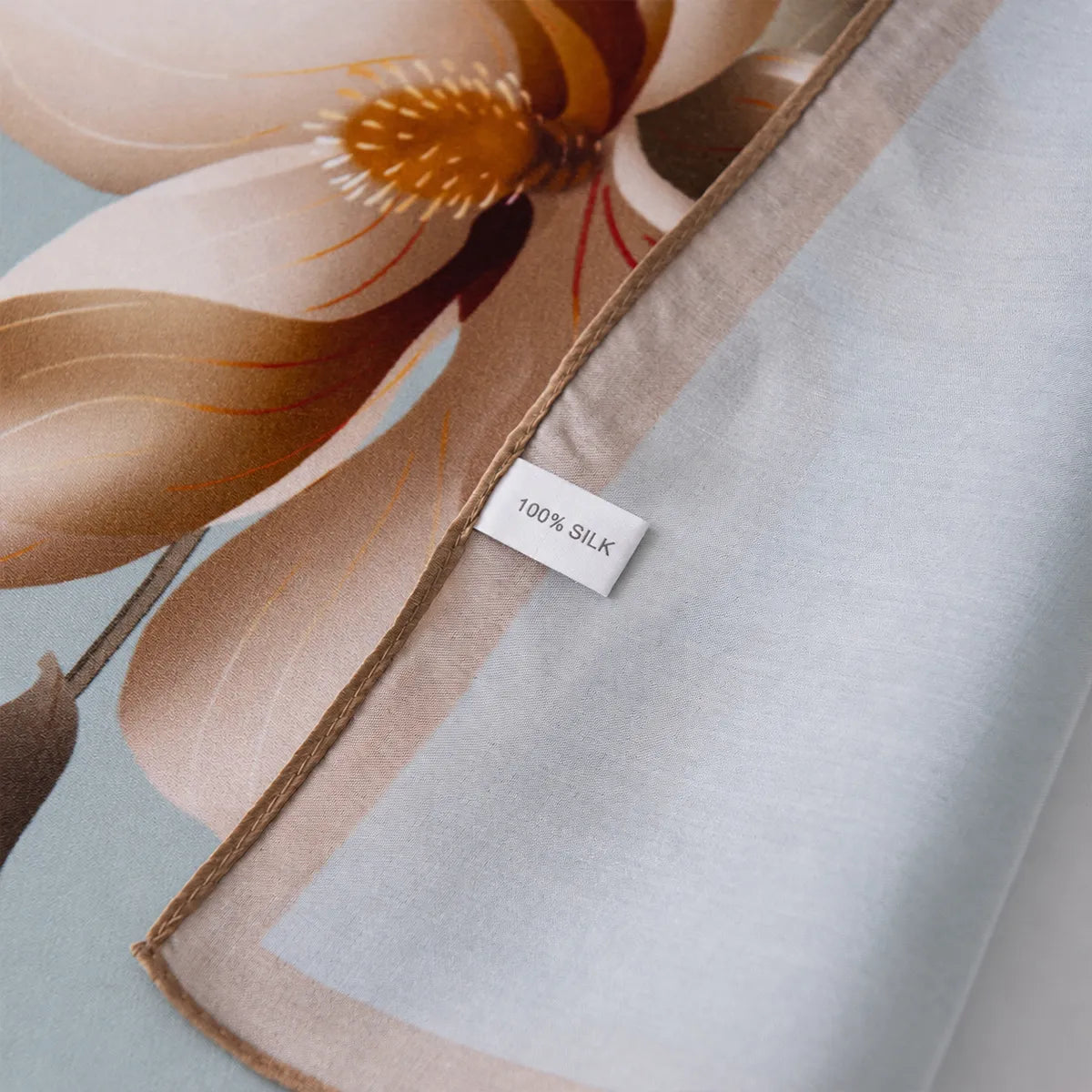 Close-up of 100% silk label on blue floral scarf