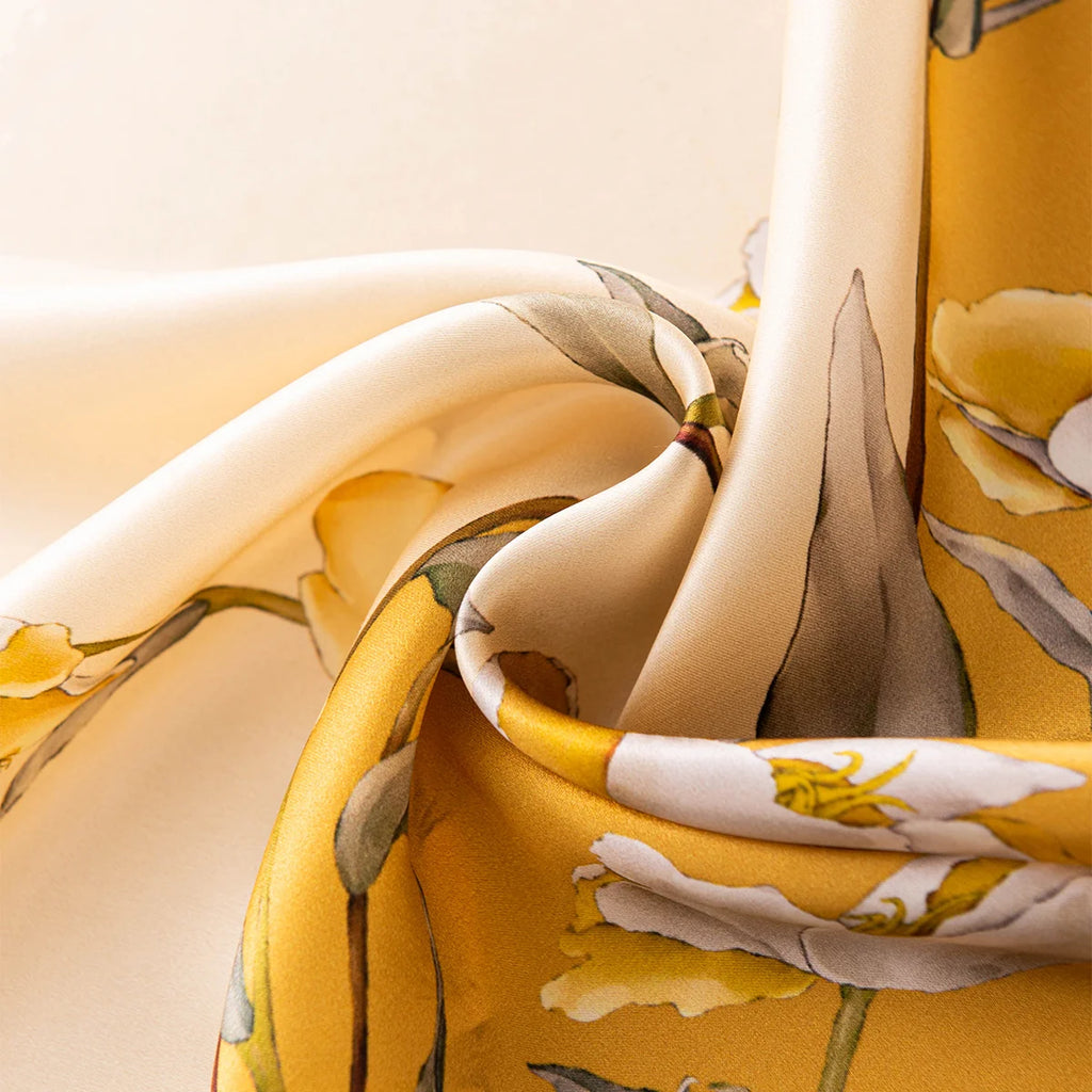 Close-up of yellow floral silk scarf fabric
