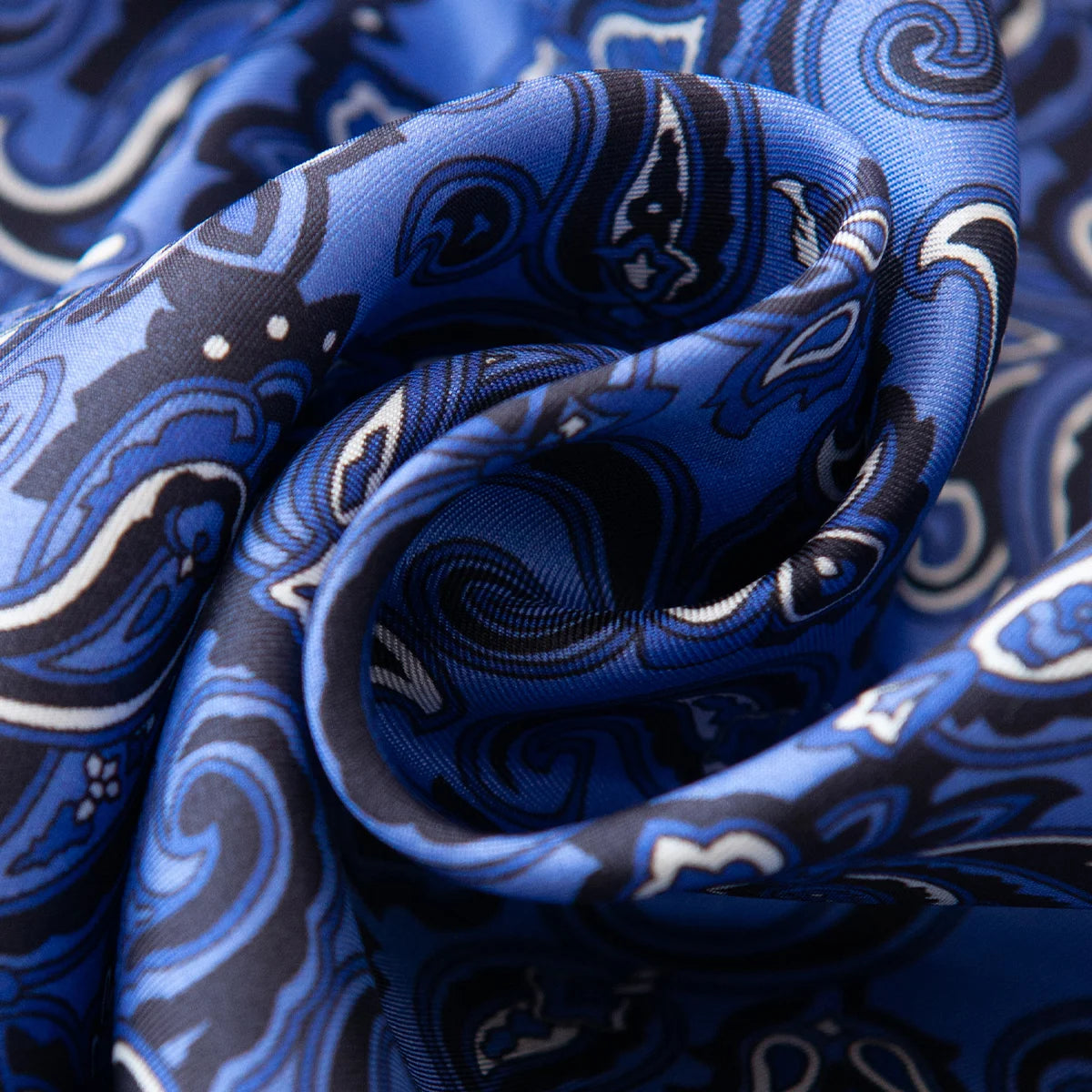 Close-up swirl of blue purple paisley silk fabric
