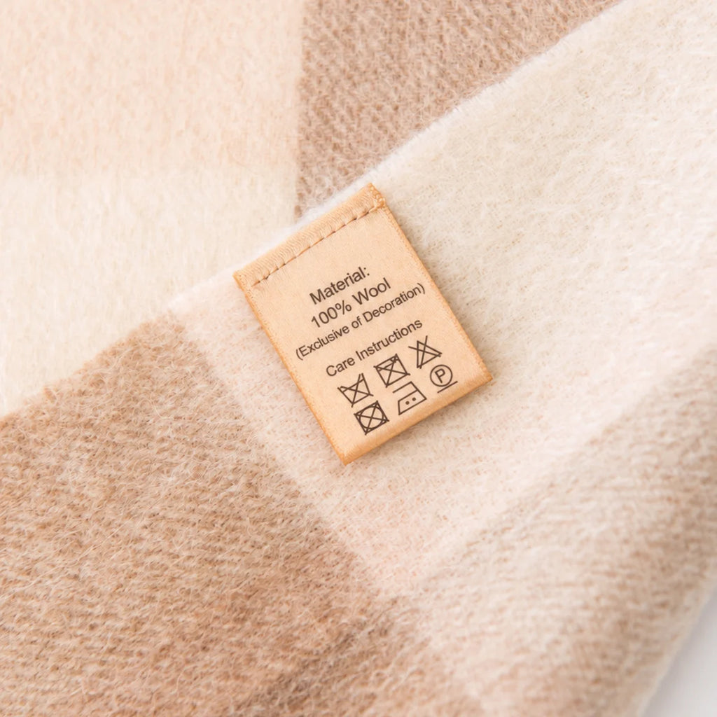 Close view of care label on cream checked fabric