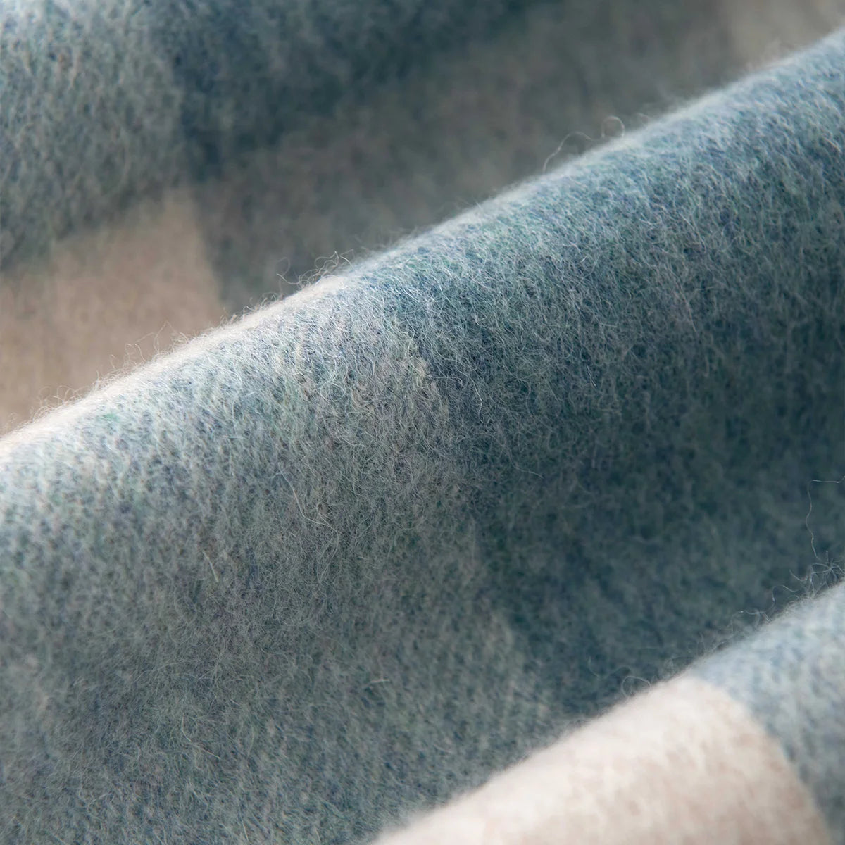 Close view of muted blue and cream woven squares