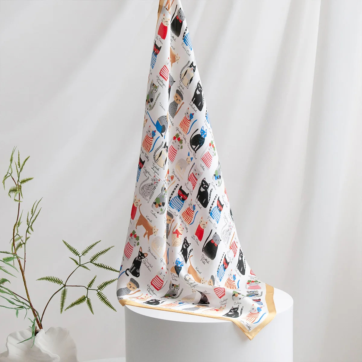 Colorful cat Silk Square Scarf styled on table