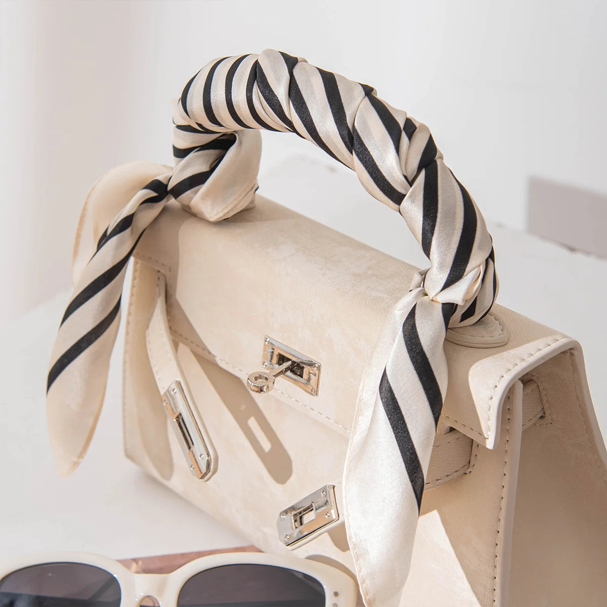Concentric square Silk Square Scarf styled on handbag