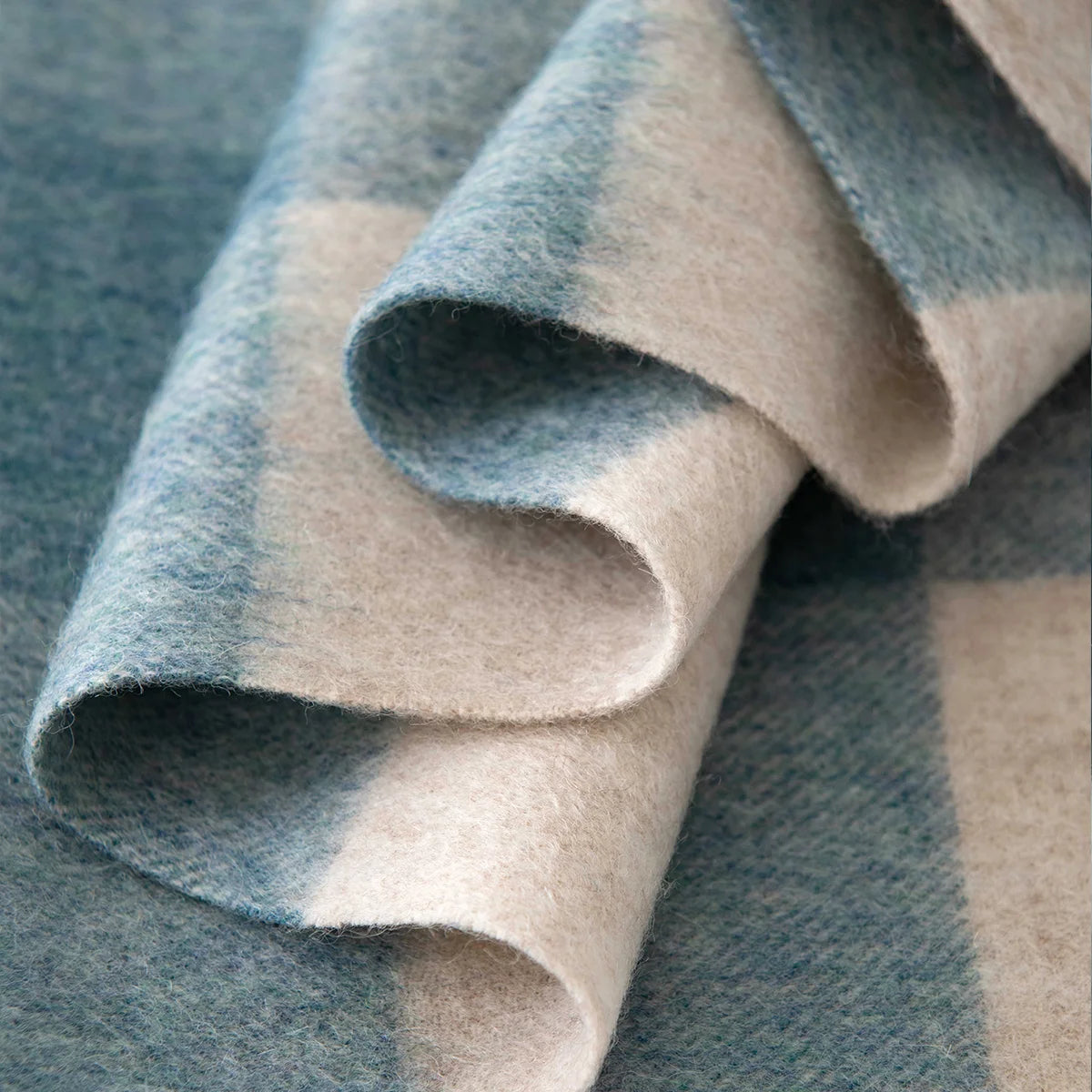 Curled blue cream checked fabric revealing brushed wool fibers