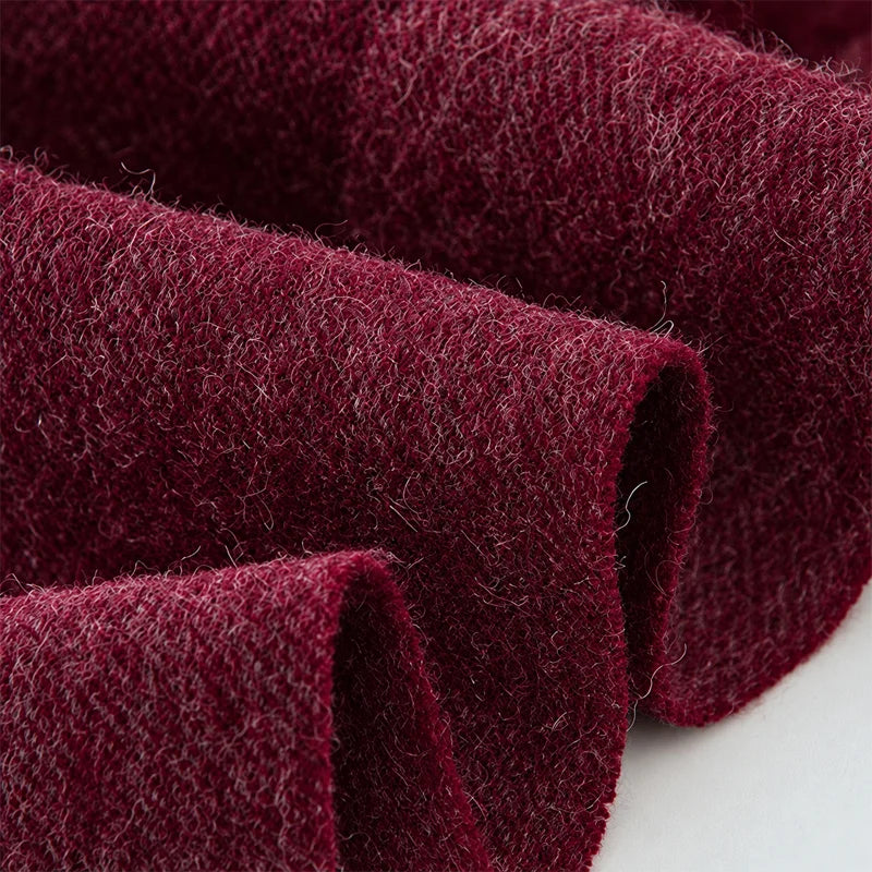 Curled burgundy wool fabric revealing a fuzzy brushed surface