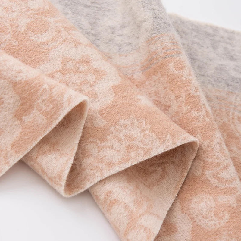 Curled peach floral fabric beside a gray patterned border