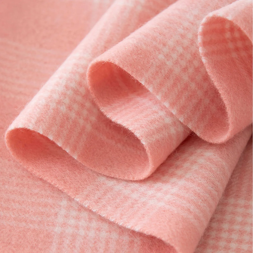 Curled pink cream checked fabric revealing fine woven detail