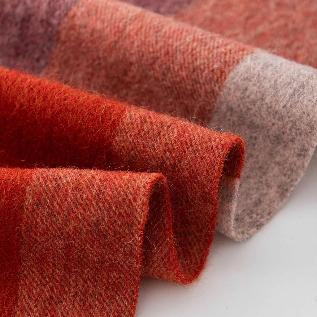 Curled rust and rose checked fabric showing brushed fibers
