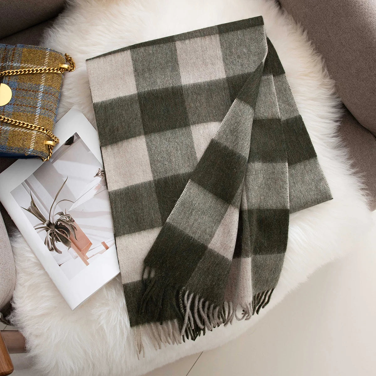 Dark green cream checked wool scarf arranged on white throw