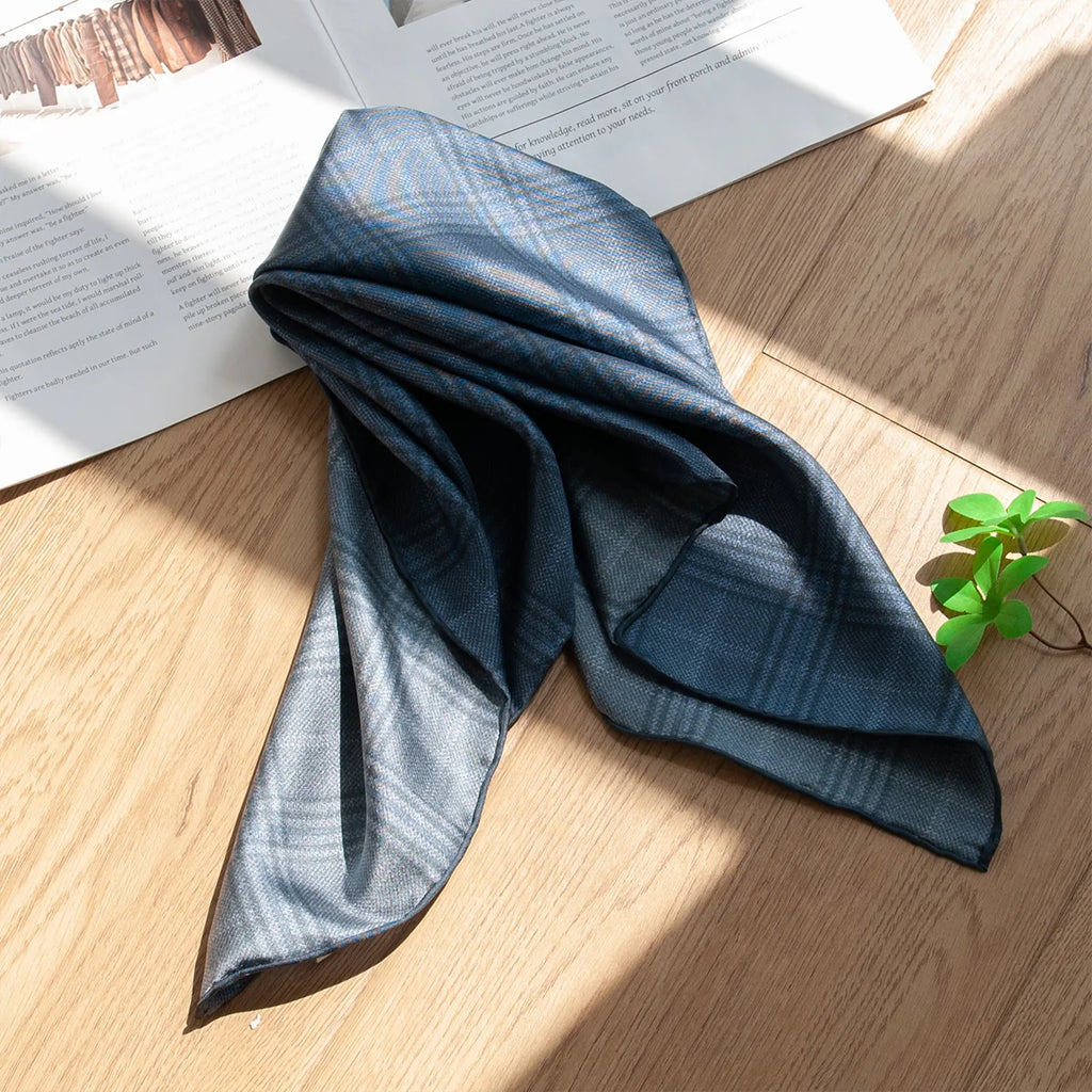 Draped blue plaid Silk Square Scarf on tabletop