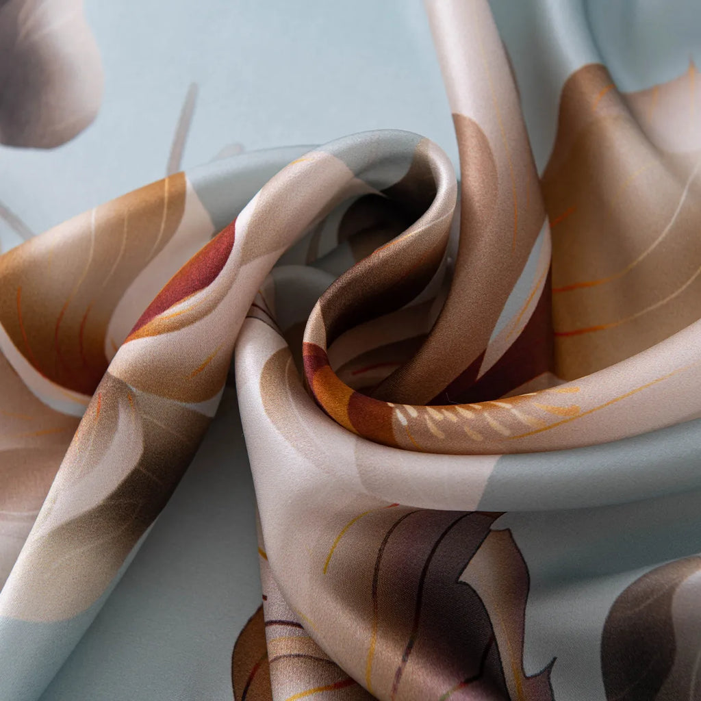 Draped light blue silk scarf showing floral pattern