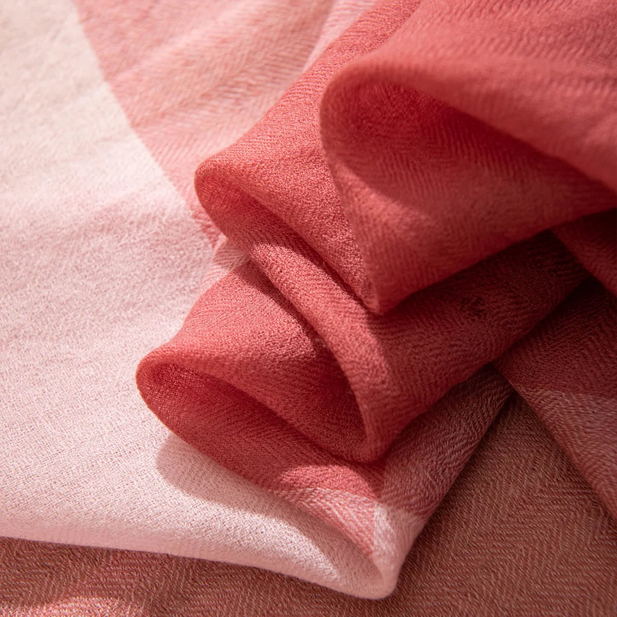 Folded rose fabric revealing lighter pink sections underneath