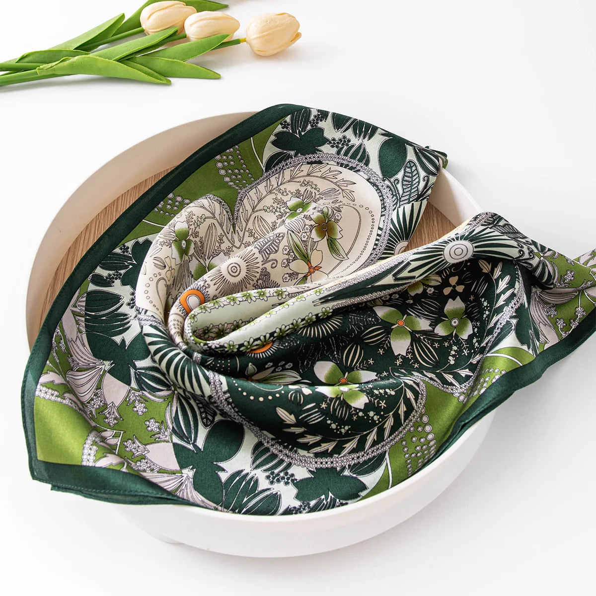 Folded botanical silk scarf in bowl