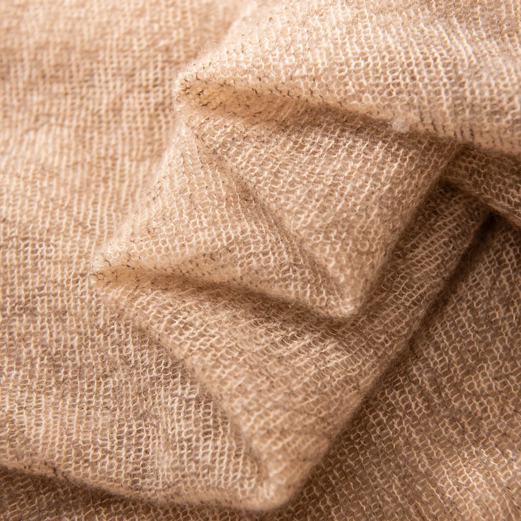 Folded camel fabric revealing an airy irregular woven texture
