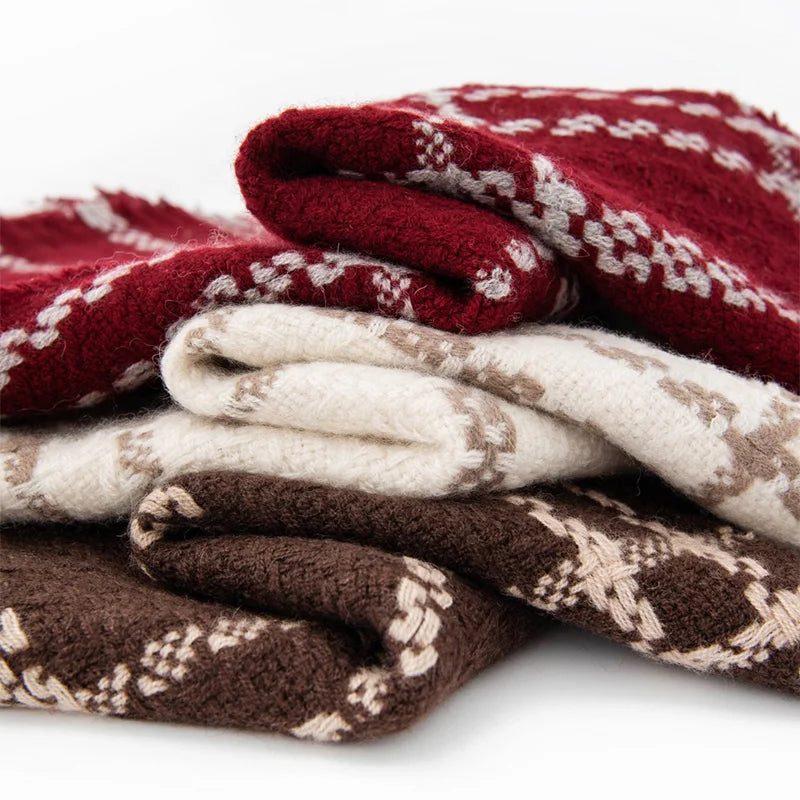 Folded chain check wool scarves stacked in three contrasting colors