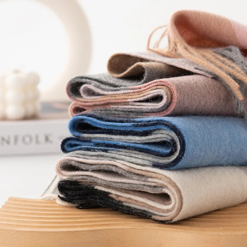 Folded checked scarves showing pink blue and neutral edges