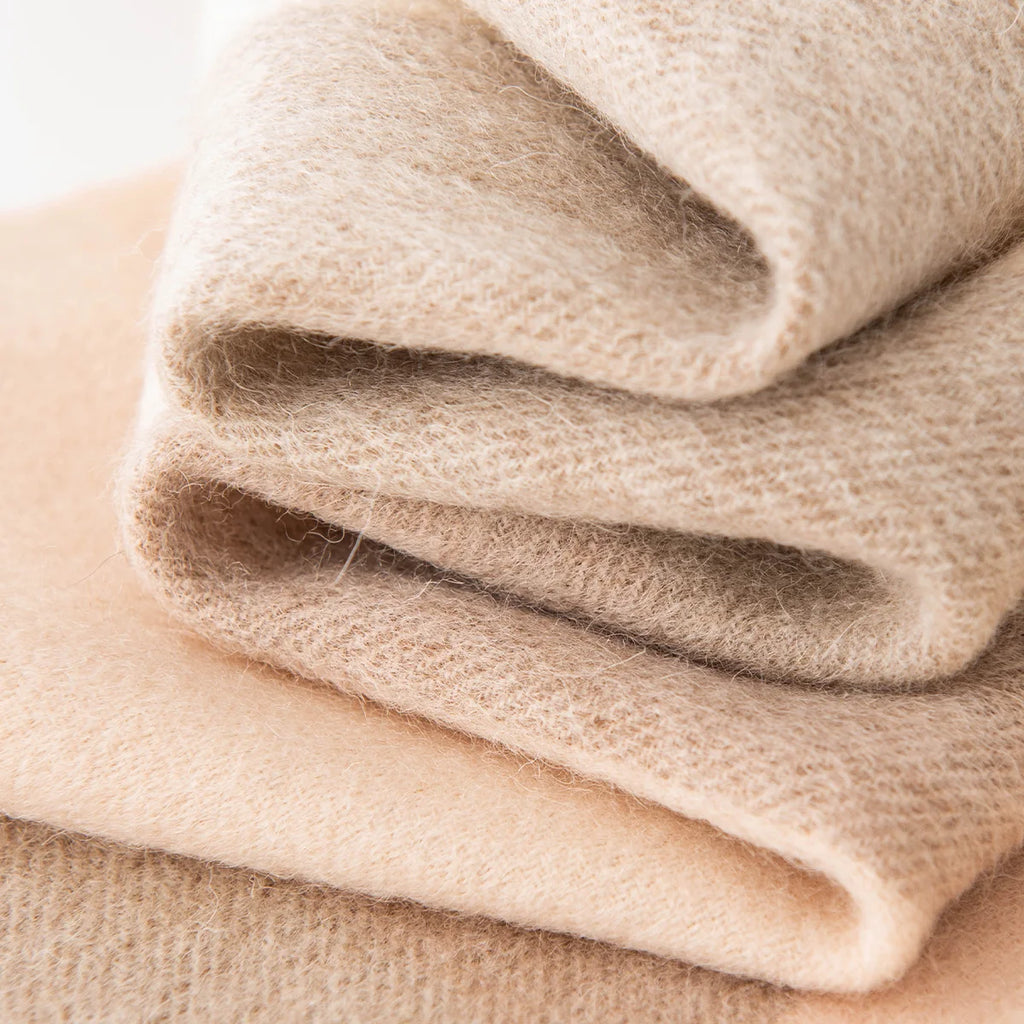 Folded cream and camel fabric showing a brushed finish