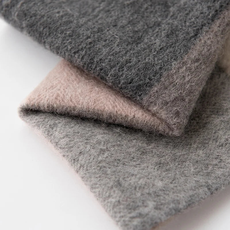 Folded gray and taupe corners revealing a fuzzy finish