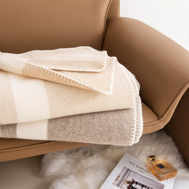 Folded neutral checked wrap resting on a tan chair