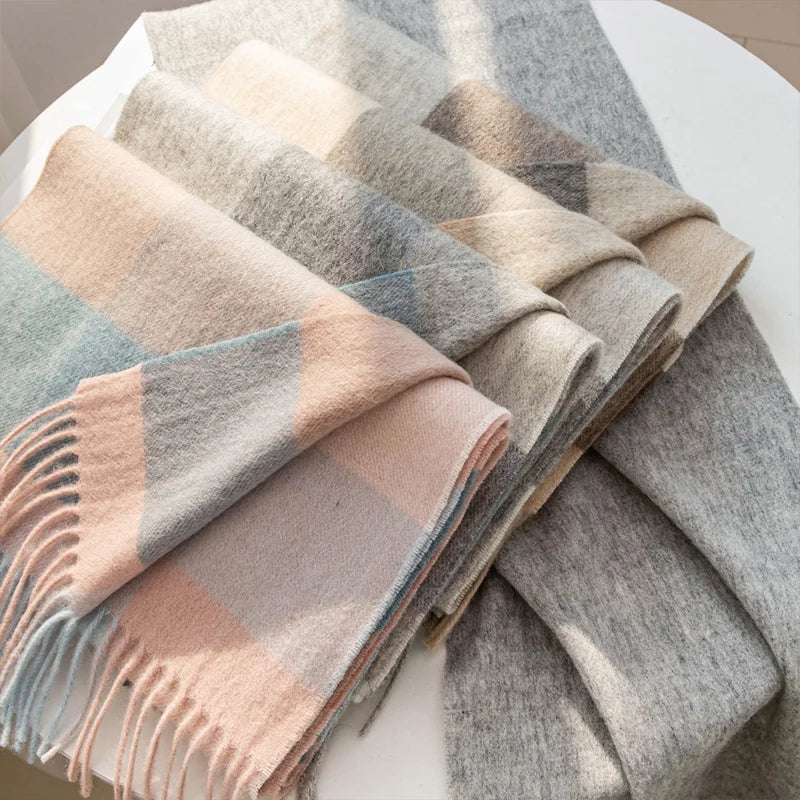 Folded pastel and neutral checked wool scarves arranged on table