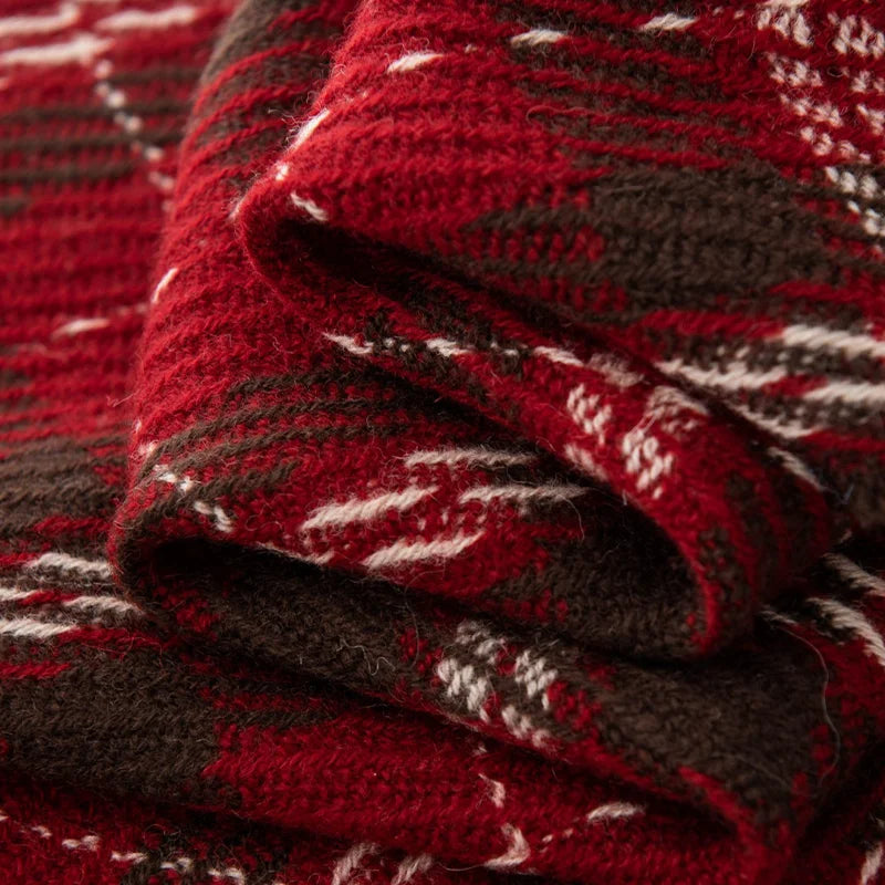 Folded red tartan fabric showing raised woven ridges