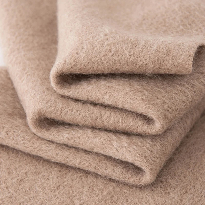 Folded taupe cashmere showing a softly brushed surface