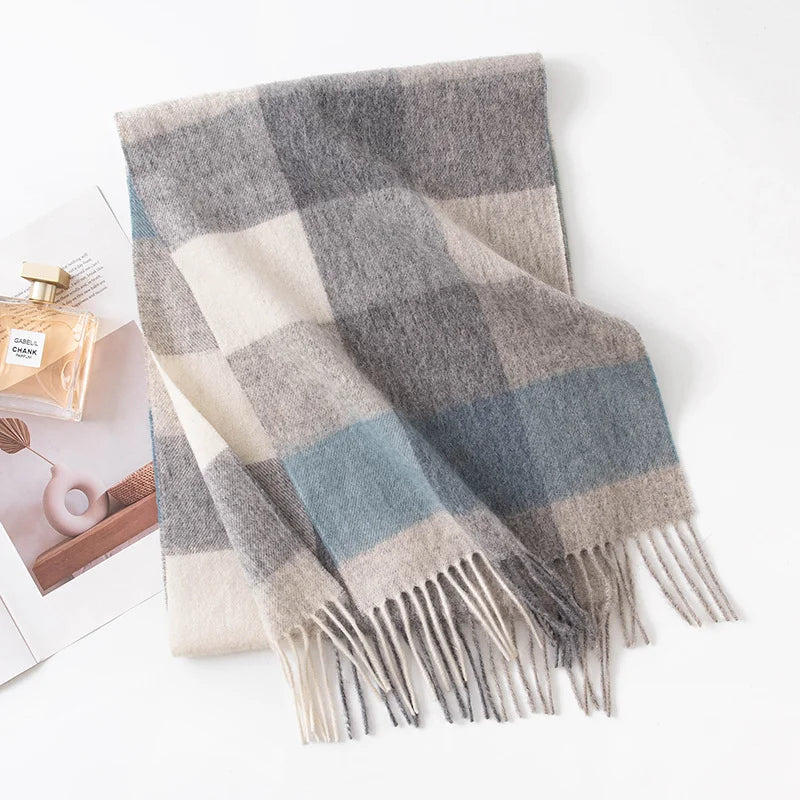 Gray blue cream block check wool scarf beside perfume bottle