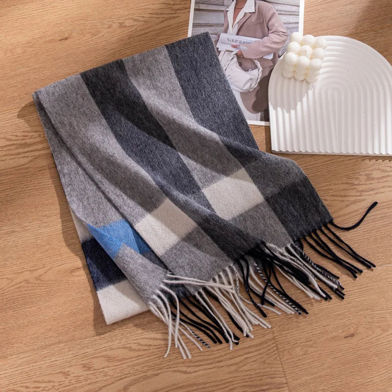 Gray striped scarf showing blue crossband on wooden surface