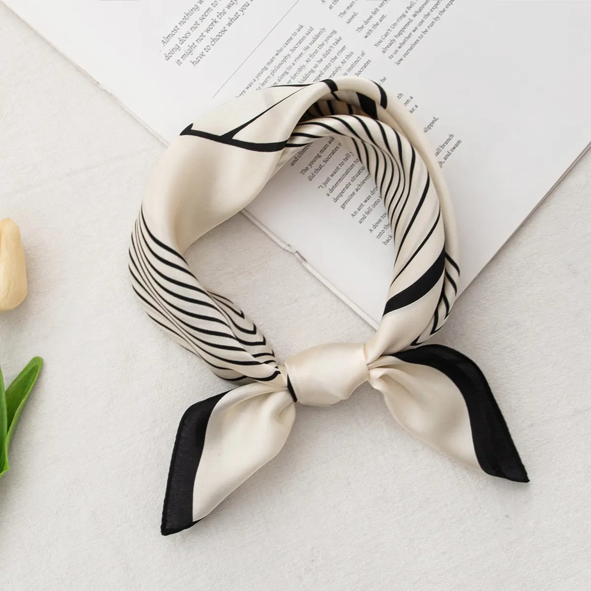 Knotted geometric silk scarf with black stripe design